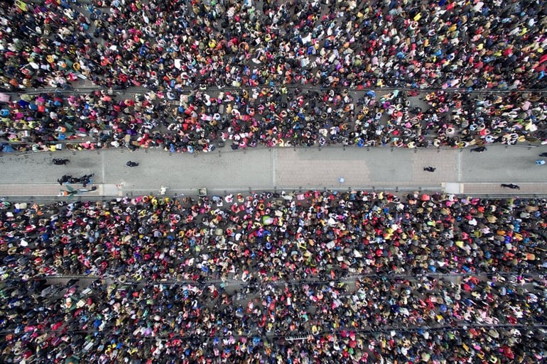 2 February 2016: An overhead view of tens of thousands of people waiting to enter Guangzhou Railway Station because of weather delays- Lin Hongxian/Southern Metropolis Daily/Reuters